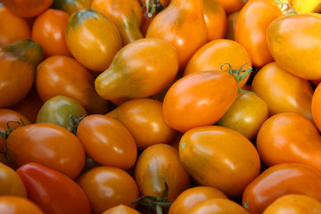 background of ripe orange tomatoes