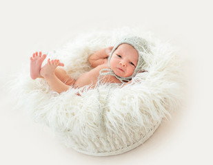 Cute newborn boy lying in a basket