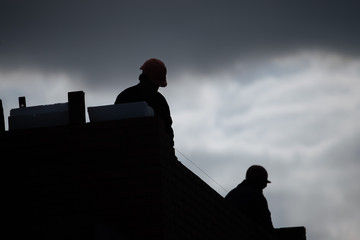Workers silhouette on construction site during development of the biulding