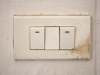 Close up of old lighting switches on concrete wall