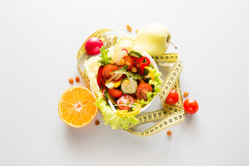 plate with fresh diet vegetables and fruits slimming food concept