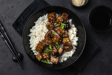 teriyaki eggplant with rice in black bowl