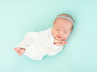 Sleeping newborn in blue headband