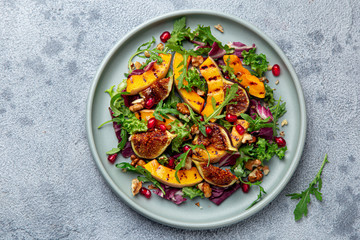 Grilled pumpkin and fig salad on blue plate