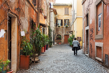 Old cobblestone narrow street and buildings in Rome, Italy