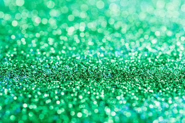 Abstract composition. Greeny blue glitter light background with beautiful bokeh, selective focus, shallow depth of field