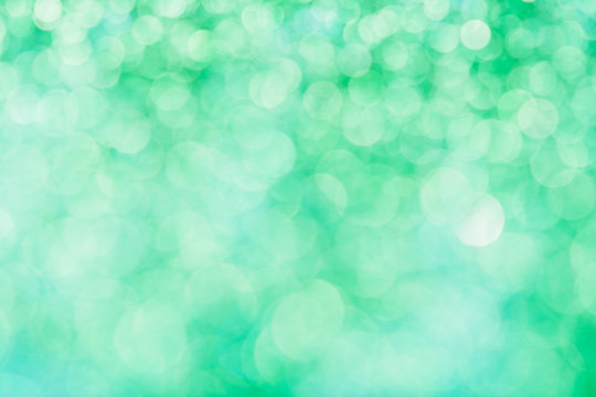 Abstract composition. Greeny blue glitter light background with beautiful bokeh