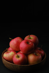 ripe red apples in wooden bowl