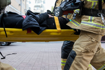  professional firefighter firefighters fireproof suits, white helmets and gas masks carry the...