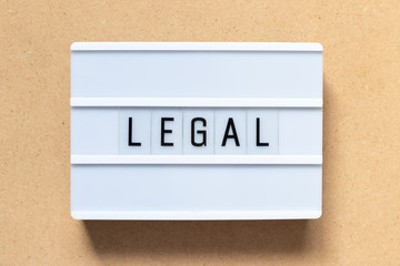 White lightbox with word legal on wood background