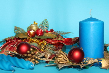 candle and Christmas decorations on blue background