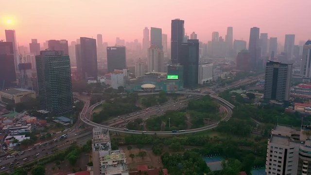 reveal view of semanggi bridge interchange Jakarta from a drone with dolly motion, during extreme air pollution. dolly motion