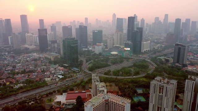 Aerial view of semanggi intersection in Jakarta while in high pollution air covering the city. Pedestal motion up to down