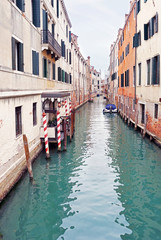 One of the canals in Venice between old houses