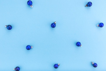 New year and Christmas concept. Christmas balls on blue background. Flat lay, copy space, top view. Christmas composition. Pattern.