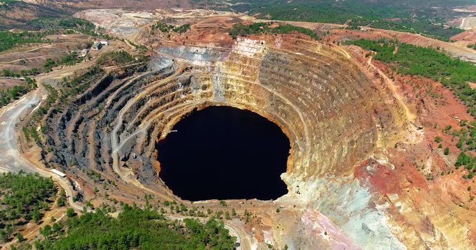 Old open pit mine of Rio Tinto in Spain with rock or ore mining. This is the production industry - industry and landscape concept