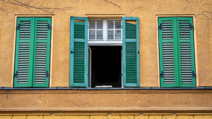 Old town house facade with the green shutters