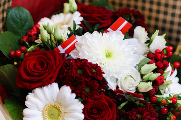 Red and white flower bouquet with Danish flags