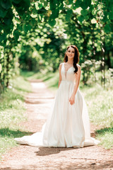 portrait of beautiful bride standing in city Park.