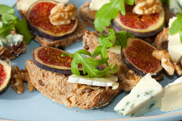 Tasty open sandwiches with fig fruits.