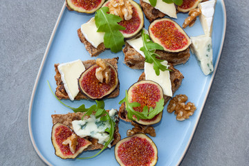 Tasty open sandwiches with fig fruits.