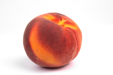 Close-up front view on one isolated colorful ripe fruit peach