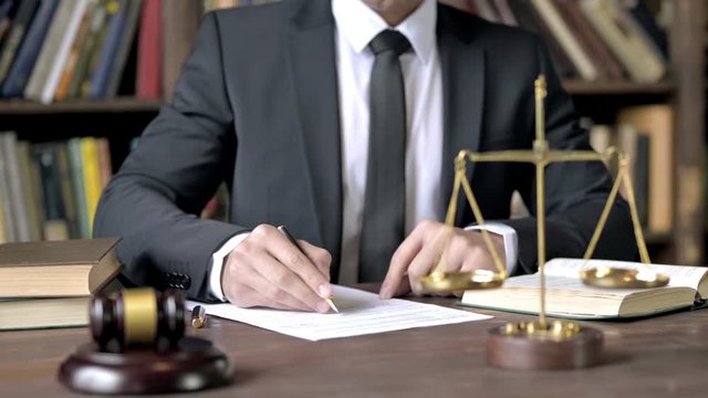 Close up Shoot of Judge Hand Signing Document in Court Room