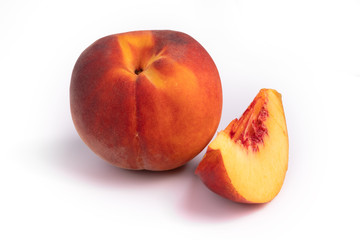Set of one whole peach and a slice of it laying on white background