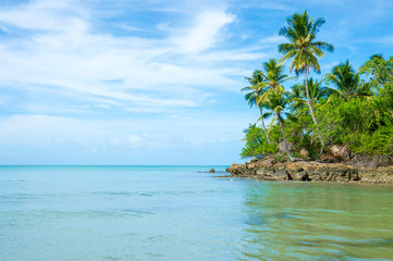 Calm scenic view of the rocky coastline of a tropical Brazilian island beach on a remote island in Bahia Brazil