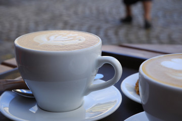 Hot cappuccino one cup with cookie on the wooden table ware