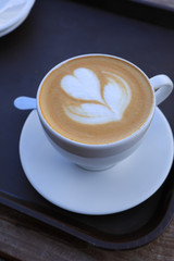 Hot cappuccino one cup with cookie on the wooden table ware