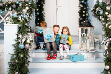 children on the stairs with New Year's gifts