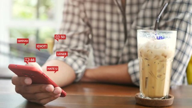 4K. people using mobile smartphone for social media interactions with notification icons of hate speech and mean comment in social network, cyber bullying concept. 
