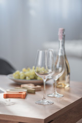 Wine glass, grape and wine bottle on wood table