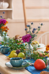 Autumn flowers, pumpkins, flowers on the festively served autumn table