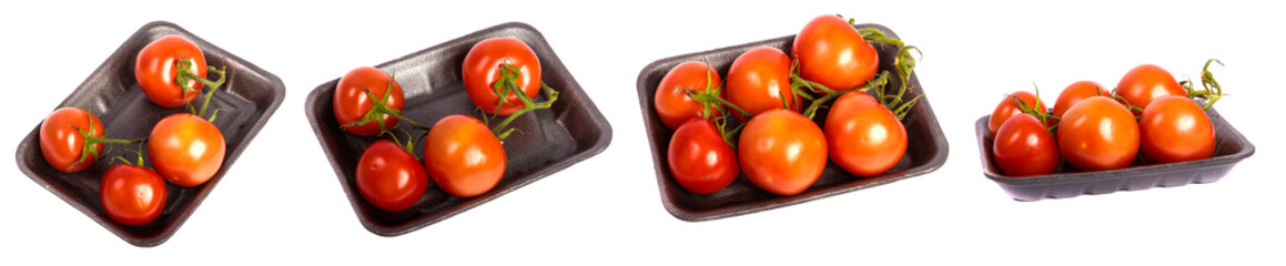 ripe red tomatoes in a dark plastic tray. on a white set