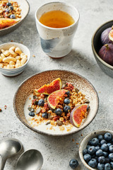 Homemade granola with yogurt, blueberry and figs for healthy breakfast.