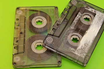 Old audio cassettes located on a green background