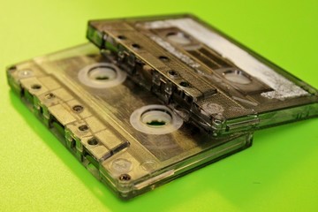 Old audio cassettes located on a green background