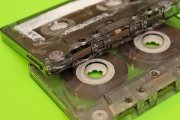 Old audio cassettes located on a green background