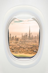 Dubai seen through the window of airplane, travel in UAE concept