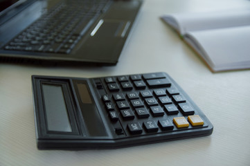 calculator and pen on table