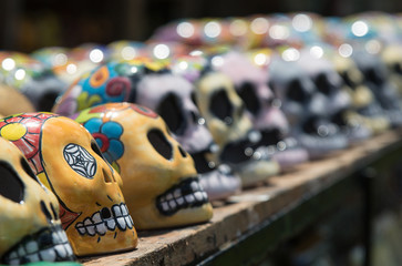 Naklejka premium Mexican colorful skulls. Traditional Mexican souvenirs. The symbol of the holiday of the day of the dead. Ceramic pottery Day of the Dead, Dia de los Muertos, skulls.