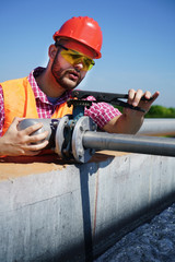                                An engineer controlling a quality of water ,aerated activated sludge tank at a waste water treatment plant