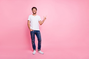 Full body photo of positive cheerful middle eastern man point index finger copyspace show ads promo...