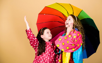 Be rainbow in someones cloud. Rainy day fun. Happy walk under umbrella. Kids girls happy friends under umbrella. Rainy weather with proper garments. Bright umbrella. It is easier to be happy together