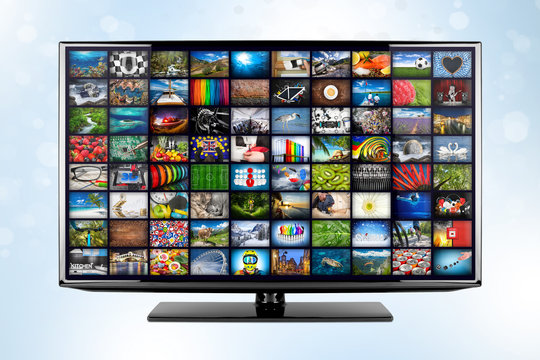 black flat tv screen monitor display with picture movie gallery backdrop. television front of blue white bokeh background. Computer multimedia streaming internet and cloud concept visualisation.