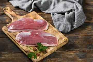 Raw duck meat on a wooden Board