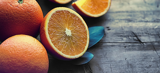 Orange citrus fruit on a stone table. Orange background.