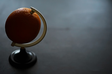 Orange citrus fruit on a stone table. Orange background.